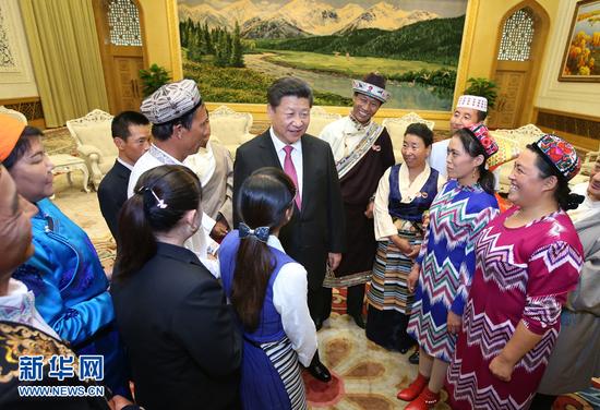 在中華人民共和國成立66周年之際，中共中央總書記、國家主席、中央軍委主席習近平特別邀請來自內蒙古、廣西、西藏、寧夏、新疆5個自治區的13名基層民族團結優秀代表到北京參加國慶活動。這是9月30日下午，習近平在人民大會堂親切會見代表們。新華社記者 姚大偉 攝